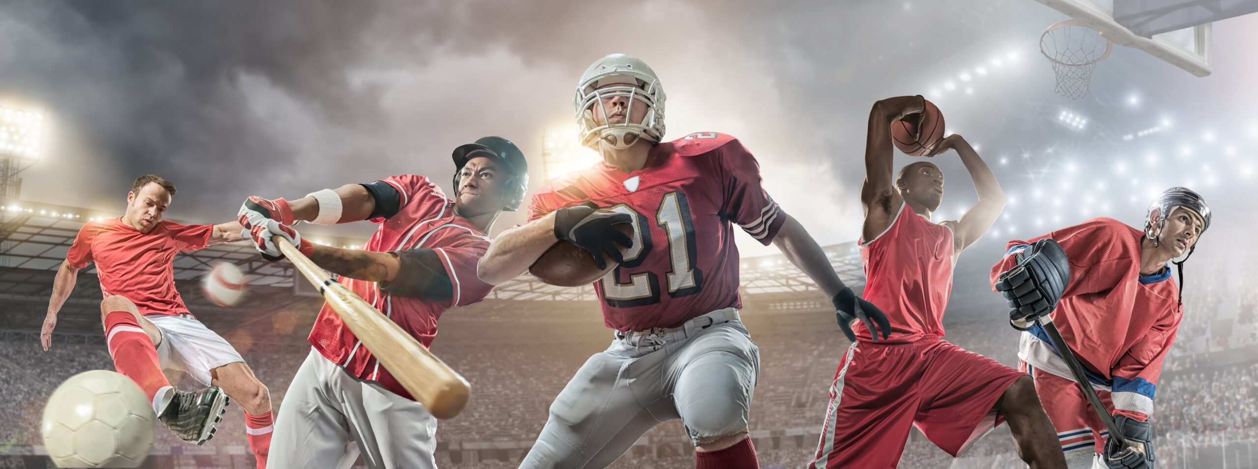 Composite image of sporting athletes in action – soccer player kicking football, baseball player swinging bat to strike baseball, American football player running and holding ball, basketball player jumping with basketball above his head, and ice hockey player holding stick. Backgrounds are generic floodlit arenas and stadiums appropriate to each sport.